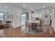 Cozy dining room with hardwood floors, natural light, and stylish décor, perfect for intimate gatherings and everyday meals at 1680 Mint River Dr, Apex, NC 27502
