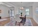 Bright dining room features stylish chandelier, and large windows at 1680 Mint River Dr, Apex, NC 27502