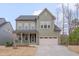 Lovely two-story home with an inviting front porch and well-manicured lawn and landscaping at 1680 Mint River Dr, Apex, NC 27502