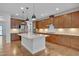 A well-lit kitchen showcasing wooden cabinets, stainless steel appliances, and a central island perfect for meal prep at 1680 Mint River Dr, Apex, NC 27502