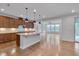 An open kitchen layout with a center island connects to a bright living area, perfect for entertaining and Gathering gatherings at 1680 Mint River Dr, Apex, NC 27502