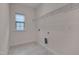 Functional laundry room featuring a window, hookups, and vinyl floors at 1680 Mint River Dr, Apex, NC 27502