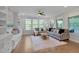 Inviting living room with custom built-ins, hardwood floors, and abundant natural light at 1680 Mint River Dr, Apex, NC 27502
