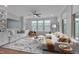 Bright living room with built-in shelves, large windows, and stylish furnishings offering a comfortable, inviting space at 1680 Mint River Dr, Apex, NC 27502