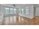 Bright and airy living space with hardwood floors, custom built-ins, and large windows creating a serene atmosphere at 1680 Mint River Dr, Apex, NC 27502