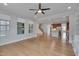 Inviting living area with views of kitchen and staircase, hardwood floors, and ample natural light creating an open ambiance at 1680 Mint River Dr, Apex, NC 27502