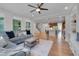 Open-concept living area features hardwood floors and seamless flow to the kitchen at 1680 Mint River Dr, Apex, NC 27502