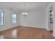Bright living room featuring hardwood floors and a view of the chandelier at 1680 Mint River Dr, Apex, NC 27502