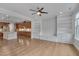 Open-concept living space showcasing hardwood floors and built-in shelving adjacent to kitchen, seamlessly blending comfort and style at 1680 Mint River Dr, Apex, NC 27502