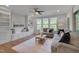 Inviting living room with custom built-ins, hardwood floors, and abundant natural light at 1680 Mint River Dr, Apex, NC 27502