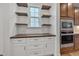 Convenient pantry area with built-in shelving and modern stainless steel appliances at 1680 Mint River Dr, Apex, NC 27502