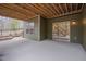 Covered back patio with exterior lighting and view to wood staircase at 1680 Mint River Dr, Apex, NC 27502