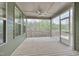 View of screened porch with wooden floors, ceiling fan and peaceful treeline view at 1680 Mint River Dr, Apex, NC 27502