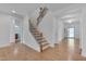 Wooden staircase with black iron railing, situated in a brightly lit home at 1680 Mint River Dr, Apex, NC 27502