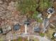 An aerial view shows a neighborhood with mature trees and well-maintained homes at 202 Oxford Hills Dr, Chapel Hill, NC 27514