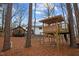 Backyard view showcasing playset, guest house, and main house at 202 Oxford Hills Dr, Chapel Hill, NC 27514