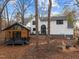 Private backyard featuring a modern cabin with a sleek deck, complemented by a spacious outdoor area at 202 Oxford Hills Dr, Chapel Hill, NC 27514