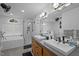 Modern bathroom featuring double sinks, a luxurious soaking tub, and a walk-in shower at 202 Oxford Hills Dr, Chapel Hill, NC 27514