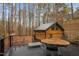 Expansive deck area with dining table and chairs, lounge chair, and a serene wooded view at 202 Oxford Hills Dr, Chapel Hill, NC 27514