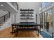 A modern dining area boasts a long dark wood table and a wall of books, flooded with natural light at 202 Oxford Hills Dr, Chapel Hill, NC 27514