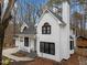 Stunning two-story home boasts a crisp white exterior, black trim, and a charming front porch at 202 Oxford Hills Dr, Chapel Hill, NC 27514