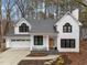 Charming two-story home with a welcoming front porch and attached garage, blending comfort and convenience at 202 Oxford Hills Dr, Chapel Hill, NC 27514