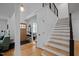 Welcoming foyer features a wooden door, staircase, and a coat rack, exuding warmth and style at 202 Oxford Hills Dr, Chapel Hill, NC 27514