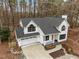 Beautiful home with a two-car garage, modern white exterior, black accents, and a cozy front porch at 202 Oxford Hills Dr, Chapel Hill, NC 27514