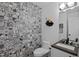 A contemporary powder room features patterned tiles, modern fixtures, and stylish decor at 202 Oxford Hills Dr, Chapel Hill, NC 27514