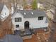 Charming home featuring black trim, a dark roof, a rear deck, stone pathways and beautiful landscaping at 202 Oxford Hills Dr, Chapel Hill, NC 27514