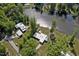 Aerial view of the property showing the home, surrounding trees and waterfront access to the lake at 2118 Timberlake Dr, Raleigh, NC 27604