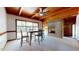 Dining area with wood vaulted ceiling, stone fireplace, large windows and neutral carpet at 2118 Timberlake Dr, Raleigh, NC 27604