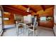 Dining area with wood vaulted ceiling, stone fireplace, large windows and neutral carpet open to the kitchen at 2118 Timberlake Dr, Raleigh, NC 27604
