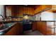 The kitchen features stainless steel appliances, brick backsplash, wooden cabinets, and dark countertops at 2118 Timberlake Dr, Raleigh, NC 27604