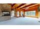 Living room with vaulted wood ceilings, large windows, stone fireplace, neutral carpet and beautiful lake views at 2118 Timberlake Dr, Raleigh, NC 27604