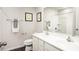 Bright bathroom featuring a double sink vanity, framed art, and a shower with white tile surround at 213 Suburban Meadow Pass, Wendell, NC 27591