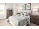 Comfortable bedroom with neutral decor, a queen-size bed, and matching bedside tables at 213 Suburban Meadow Pass, Wendell, NC 27591