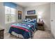 Cozy bedroom with playful space themed decor, neutral walls, and a bright sunny window at 213 Suburban Meadow Pass, Wendell, NC 27591