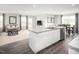 Open-concept kitchen and living area, with granite countertops, stainless steel appliances, and hardwood floors at 213 Suburban Meadow Pass, Wendell, NC 27591