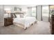 Spacious main bedroom featuring neutral walls, carpeted floor, and a large bed with lamps and decor at 213 Suburban Meadow Pass, Wendell, NC 27591