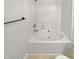 Bathroom featuring soaking tub, shower head, towel rack, and white tiles at 2356 Bay Harbor Dr, Raleigh, NC 27604