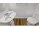 Bathroom with pedestal sink, white toilet, and wood-look floors at 2356 Bay Harbor Dr, Raleigh, NC 27604