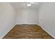 Bedroom featuring wood-look floors, white walls, ceiling fan and two doors at 2356 Bay Harbor Dr, Raleigh, NC 27604