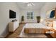 Light and airy bedroom showcasing modern decor, hardwood floors, and a large window for ample natural light at 2356 Bay Harbor Dr, Raleigh, NC 27604