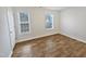 Bedroom featuring wood-look floors and natural light from two windows at 2356 Bay Harbor Dr, Raleigh, NC 27604
