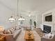 Bright, virtually staged living room featuring hardwood floors, a cozy fireplace, and modern chandelier at 2356 Bay Harbor Dr, Raleigh, NC 27604