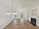 Open-concept living room featuring hardwood floors and modern fireplace, offering a bright and airy feel at 2356 Bay Harbor Dr, Raleigh, NC 27604