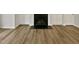 Living room with built in cabinets, fireplace, and wood-look floors at 2356 Bay Harbor Dr, Raleigh, NC 27604
