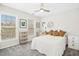 Bright bedroom with plush carpet, ceiling fan, and three large windows at 248 Sweet Bay Pl, Carrboro, NC 27510
