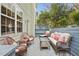 Relaxing deck space with wicker furniture, colorful cushions, and serene backyard views at 248 Sweet Bay Pl, Carrboro, NC 27510